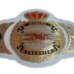 The TNA Women's Heavyweight Wrestling Championship Title Belt is a distinguished emblem of dominance and achievement in women's professional wrestling. This belt features a striking central plate with intricate engravings that highlight the TNA logo, surrounded by elegant designs that symbolize strength, resilience, and the storied history of women's wrestling in TNA. The central plate is complemented by two smaller side plates, each crafted with equal attention to detail, showcasing symbols that represent the power and prestige of the championship. The belt is crafted with high-quality materials, including gold-plated brass or zinc metal plates that give it a luxurious and commanding appearance. The 3mm genuine cowhide leather strap ensures both durability and comfort, while the inner soft fabric lining with foam padding adds an extra layer of comfort for the champion. The belt's full length, measuring approximately 50 inches, fits up to a 46-inch waist, secured by a reliable snap closure. This title belt stands as a testament to the unparalleled skill and dedication of the women who vie for it, representing the pinnacle of success in TNA’s women's division.